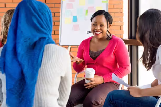 A facilitator leading a discussion with a group of participants